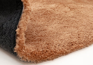 A close up of a terracotta rug on a white background.
