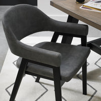 Up close view of the Candice Dark Grey Fabric Dining Chairs with Armrests and Oak Frame.