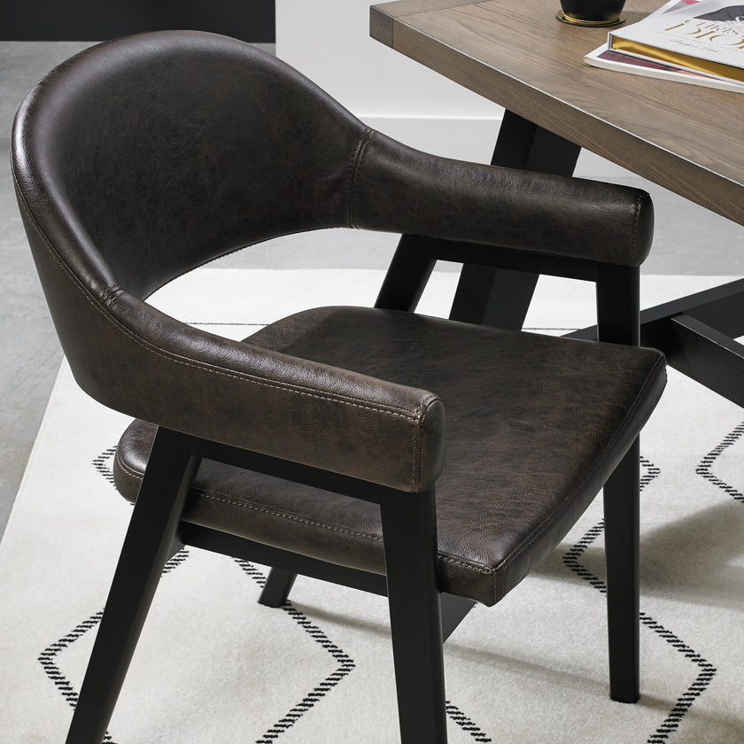 Angled and up close view of the Candice Upholstered Dining Chairs with arm rests and oak frame.