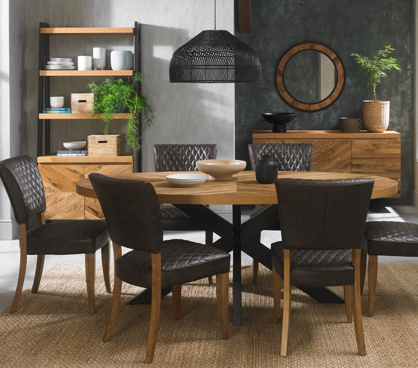 Image of the Elliot Rustic Oak Oval Dining Table styled with NCF's Dining Furniture.