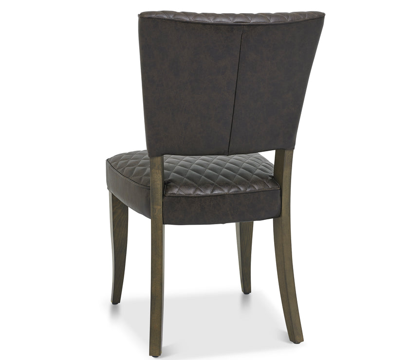 Back and angled Image of the Landon Fumed Oak Dining Chairs Saddle Faux Leather with dark oak frame styled with NCF's Dining Furniture.
