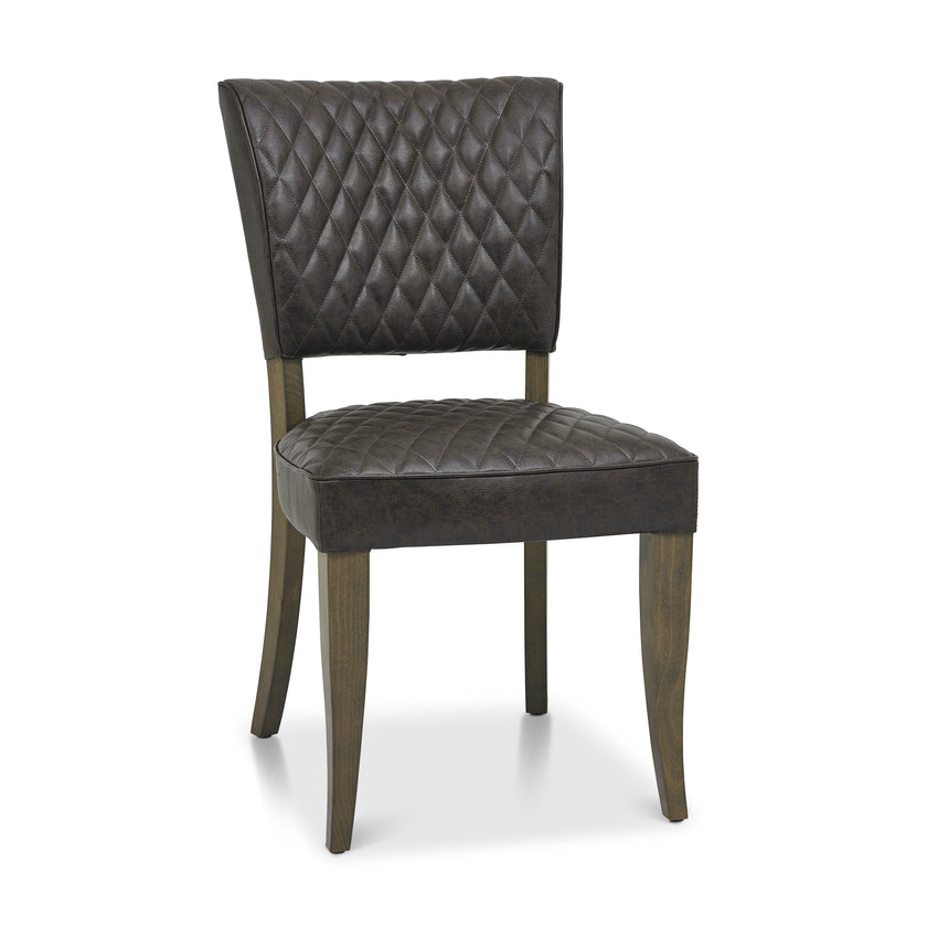 Angled and front Image of the Landon Fumed Oak Dining Chairs Saddle Faux Leather with dark oak frame styled with NCF's Dining Furniture.

