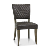 Angled and front Image of the Landon Fumed Oak Dining Chairs Saddle Faux Leather with dark oak frame styled with NCF's Dining Furniture.
