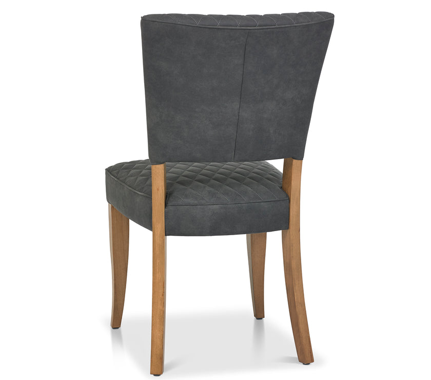 Angled and back view of the Landon Rustic Oak Dining Chairs with lightly oiled oak frame and dark grey fabric seat.