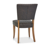 Back and angled image of the Landon Rustic Oak Dining Chairs with lightly oiled oak frame and saddle brown faux leather seat.