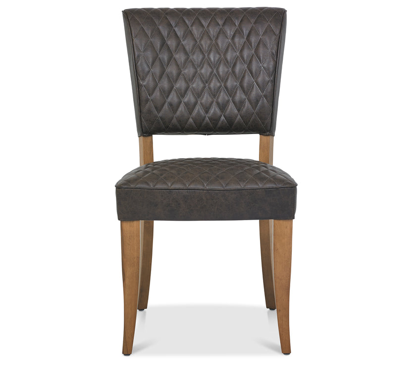 Front image of the Landon Rustic Oak Dining Chairs with lightly oiled oak frame and saddle brown faux leather seat.