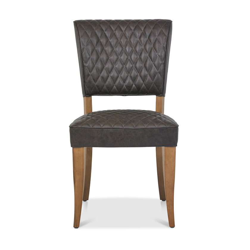 Front image of the Landon Rustic Oak Dining Chairs with lightly oiled oak frame and saddle brown faux leather seat.