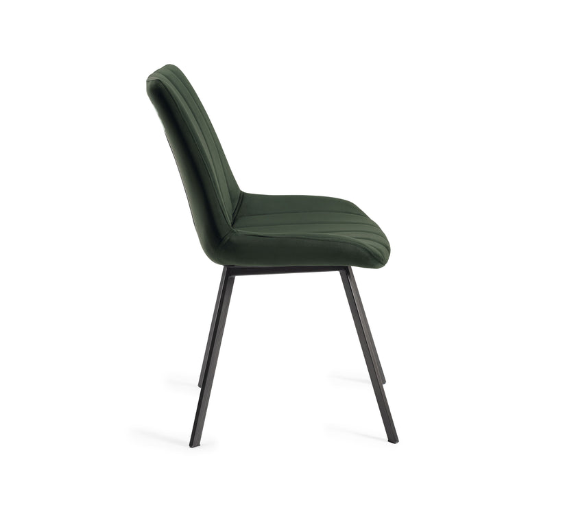 Side view of the Savio Dining Chairs in green velvet with vertical stitching and metal legs.