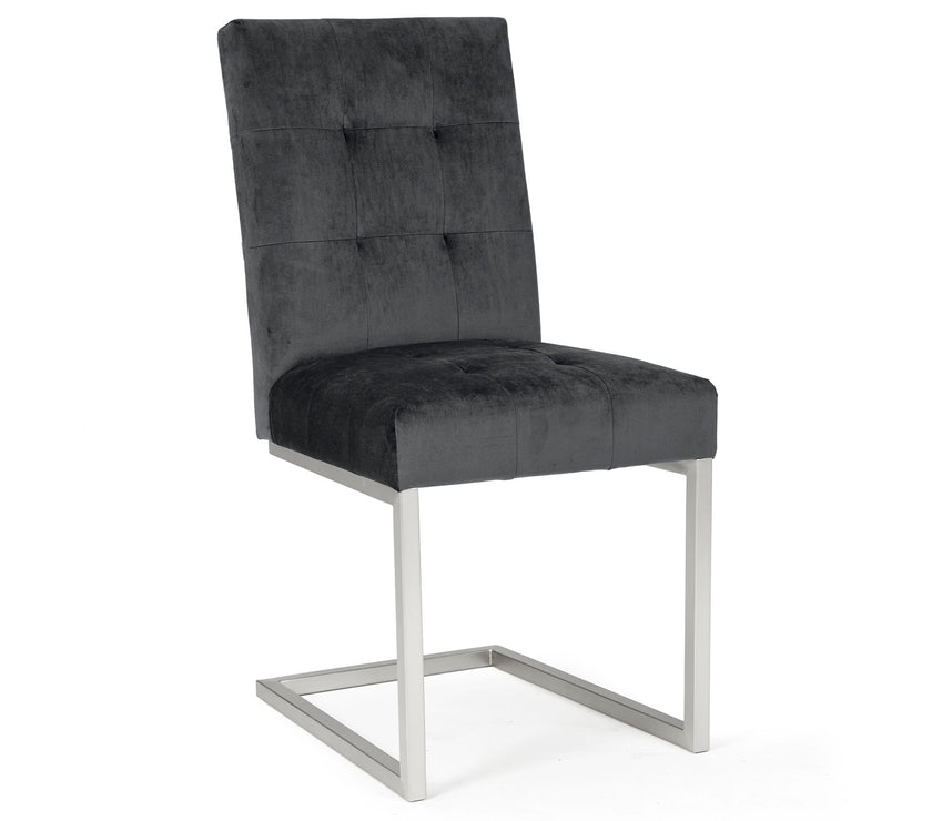 Angled and front view of the Toulouse Velvet Dining Chairs with gunmetal fabric, chrome cantilever frame, and quilted button detailing.