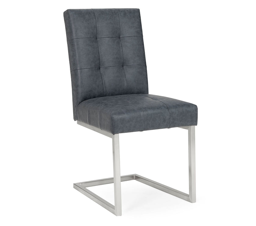Angled and front view of the Toulouse Cantilever Faux Leather Dining Chairs with dark oiled oak, black oak accents, and satin nickel frame.