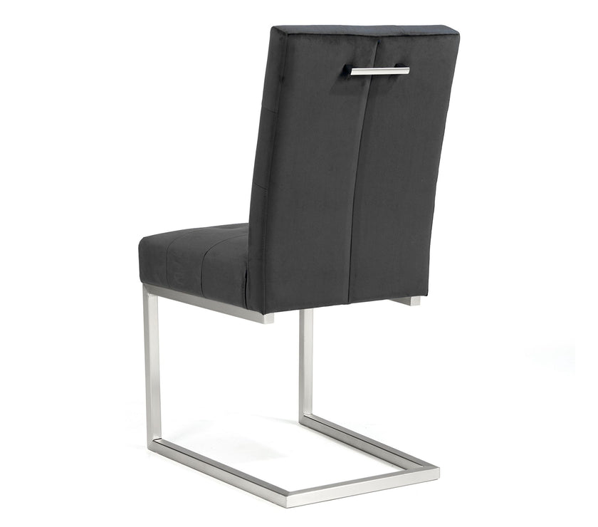 Angled and back view of the Toulouse Velvet Dining Chairs with gunmetal fabric, chrome cantilever frame, and quilted button detailing.